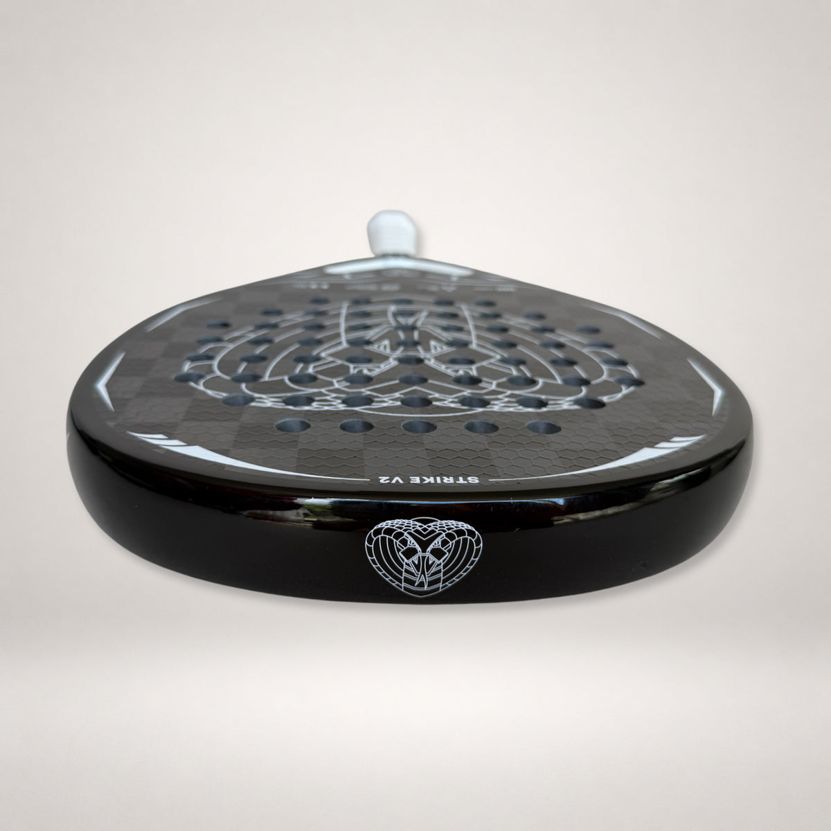 18K carbon and textured surface detail of Strike V2 racket